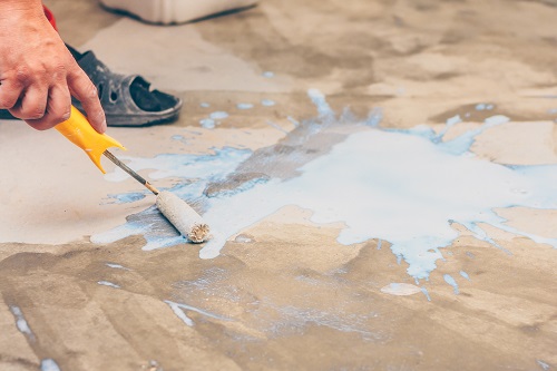 Priming concrete with roller brush