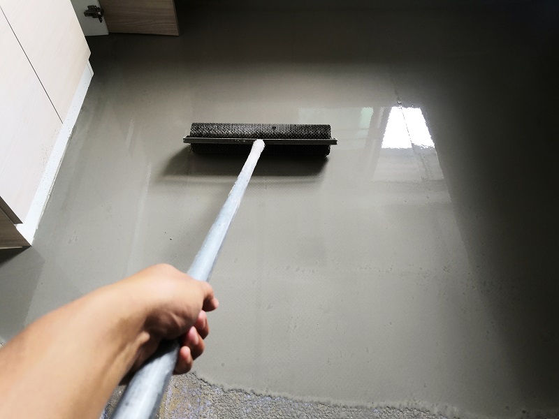 Applying coating to concrete floor